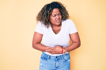 Young african american plus size woman wearing casual white tshirt with hand on stomach because nausea, painful disease feeling unwell. ache concept.