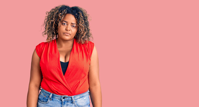 Young african american plus size woman wearing casual style with sleeveless shirt looking sleepy and tired, exhausted for fatigue and hangover, lazy eyes in the morning.