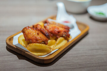Grilled chicken wings in a wooden tray