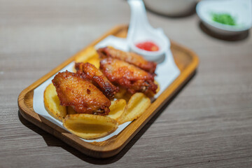 Grilled chicken wings in a wooden tray