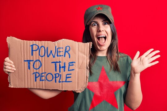 Beautiful woman wearing t-shirt with red star communist symbol asking for social movement celebrating achievement with happy smile and winner expression with raised hand