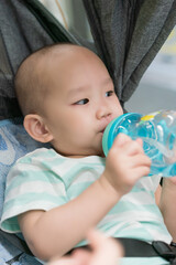 The mother took her child on the subway and the baby was drinking water