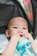 The mother took her child on the subway and the baby was drinking water