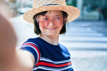 Beautiful brunette woman with down syndrome at the town on a sunny day wearing fashion heart shaped...