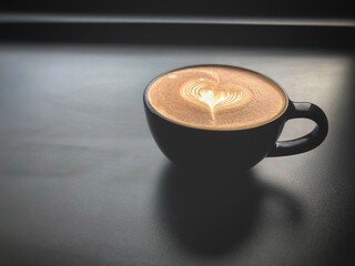 The cappuccino coffee cup put on table,blurry light around