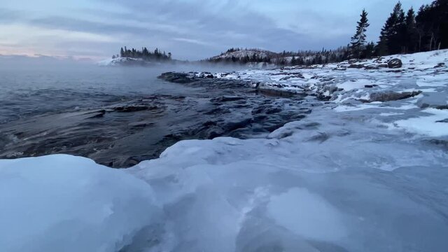 lake superior on winter time seen from split rock light house in minnesota, blue hour