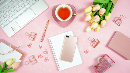 Feminine pink theme desktop workspace with laptop on stylish textured background. Top view blog hero header creative composition flat lay.
