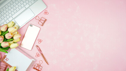 Feminine pink theme desktop workspace with laptop on stylish textured background. Top view blog...
