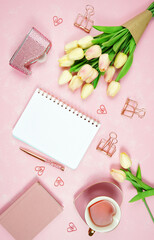 Feminine pink theme desktop workspace with notepad on stylish textured background. Top view blog hero header creative composition flat lay.