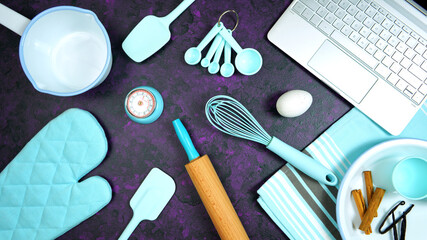 Cooking baking food theme desktop workspace with laptop on stylish purple textured background. Top view blog hero header creative composition flat lay. Stop motion animation.