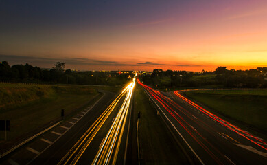 Fototapeta na wymiar traffic on highway at sunset