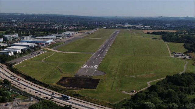 Aerial orbit shot. Southampton International Airport Runway aerial drone shot. UK flights, transportation. COVID-19 means lack of flights, quiet. Flybe job losses.