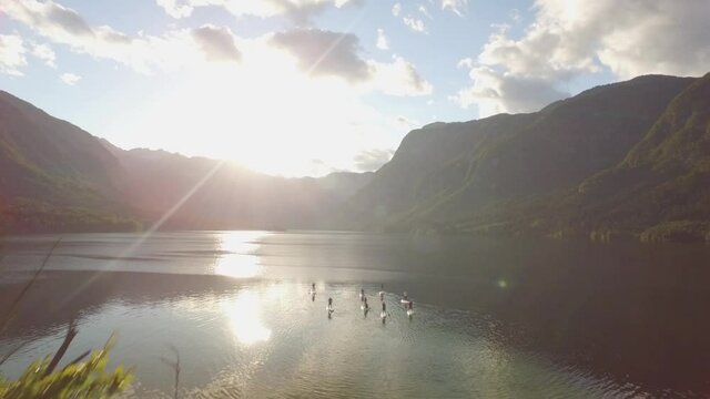 Revealing shot of sups in the lake
