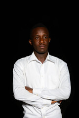 Obraz premium Young African businessman in the dark against black background