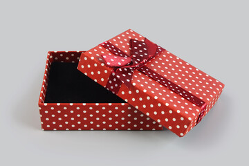 Red color elegant gift box on gray background