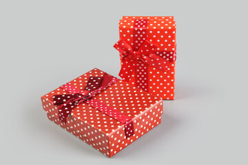 Red color elegant gift box on gray background