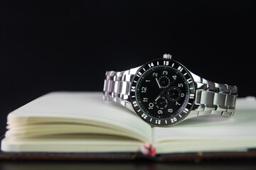 Men's wrist watch on Notebook or Business Planner