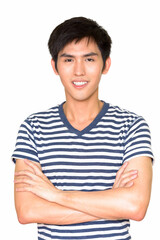 Fototapeta premium Studio shot of confident young handsome Asian man smiling against white background