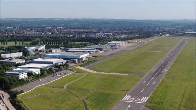 Southampton International Airport Runway aerial drone shot. UK flights, transportation. COVID-19 means lack of flights, quiet. Flybe aircraft. Jobs loss, travel ban.