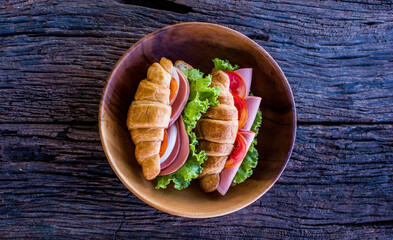 Freshly croissant sandwich on wooden background. It is a type of French pastry suitable as breakfast. No one doesn't know the croissant and can be purchased at bakery worldwide.