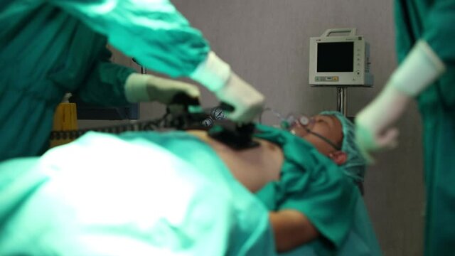 Doctors are helping patients with machines defibrillation.