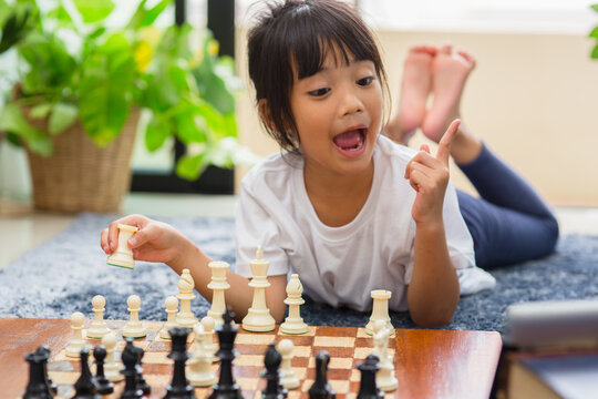 little girl having online chess lesson, e-education, distance learning