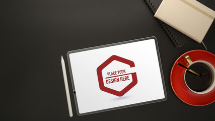 Workplace with mock up digital tablet, coffee cup, diary books and copy space on black table