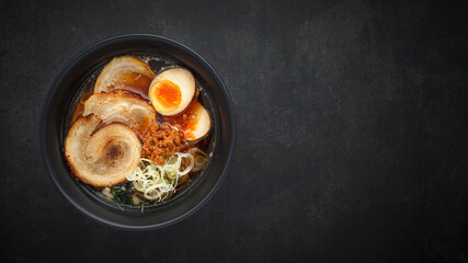 top view Asian ramen noodle soup with Chashu (Japanese braised pork belly), Nitamago egg, sliced...