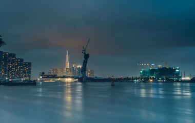 Raining view of skyline with landmark 81 skyscraper, a new cable-stayed bridge is building connecting Thu Thiem peninsula and District 1 across the Saigon River.