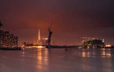 Obraz premium Raining view of skyline with landmark 81 skyscraper, a new cable-stayed bridge is building connecting Thu Thiem peninsula and District 1 across the Saigon River.