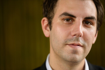 Obraz premium Portrait of businessman in suit against bamboo wall outdoors