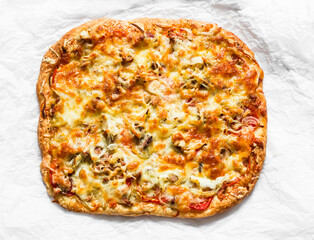 Delicious tapas, snack, appetizer. Canned tuna, tomatoes, mozzarella cheese pizza on a light background, top view