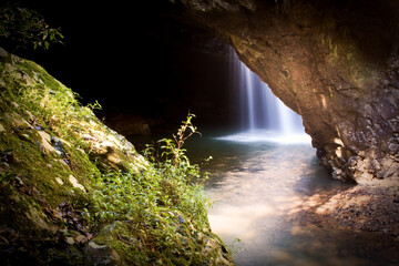 Fototapeta na wymiar A Waterfall in a cave in Queensland, Australia called Natural Bridge.