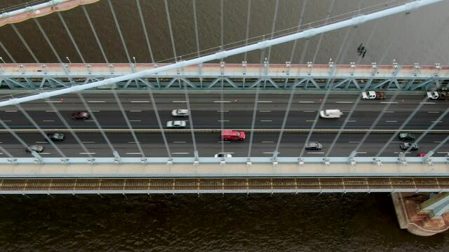 Top down aerial of traffic crossing Ben Franklin suspension bridge in Philadelphia USA, transportation and logistics theme, daily commuter traffic