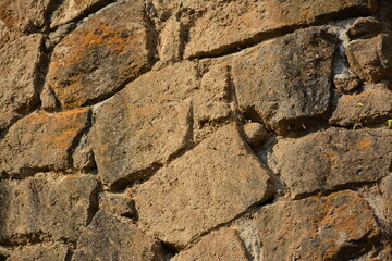Brown old rock boulder build layer wall