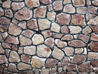 Stone wall background. Background of stone wall of boulders and pebbles