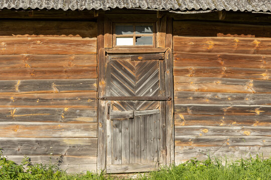 Old barn wooden doors at bright sunlight