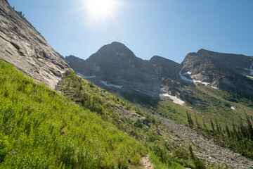 Steep rocky slope and slide in Valhalla provincial park, West Kootenays, BC, bright sun in the frame.