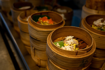 Variety of dim sum in bamboo basket. Chinese breakfast style in Southern of Thailand.