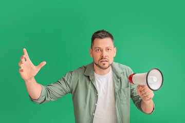 Protesting man with megaphone on color background