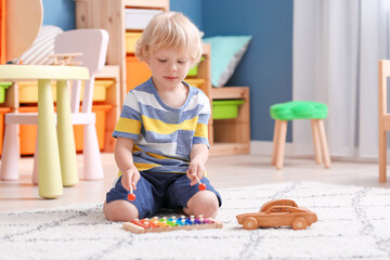 Cute little boy playing in kindergarten