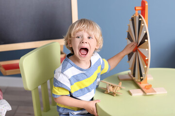 Cute little boy playing in kindergarten