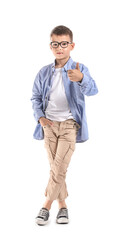 Naklejka premium Cute little boy showing thumb-up on white background