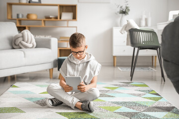 Cute little boy with tablet computer at home