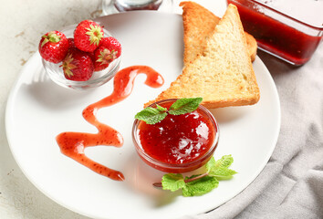 Bread with tasty strawberry jam on table