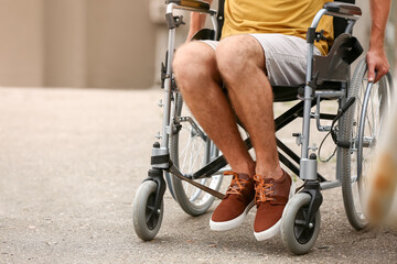 Young man in wheelchair outdoors