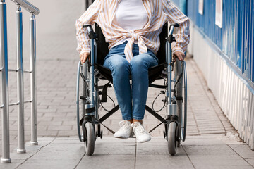 Young woman in wheelchair outdoors