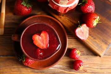Sweet strawberry jam on table