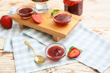 Sweet strawberry jam on table