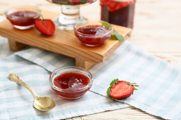 Sweet strawberry jam on table